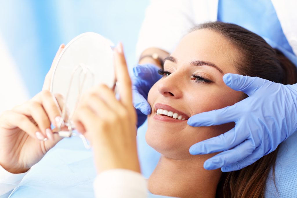 Woman dentist looking at teeth