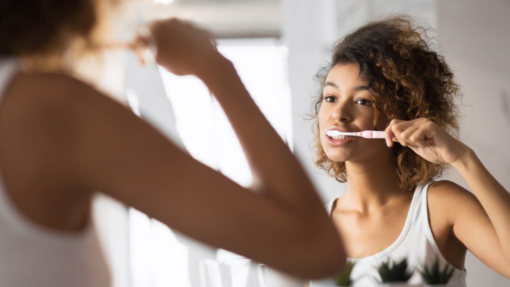 women brushing teeth