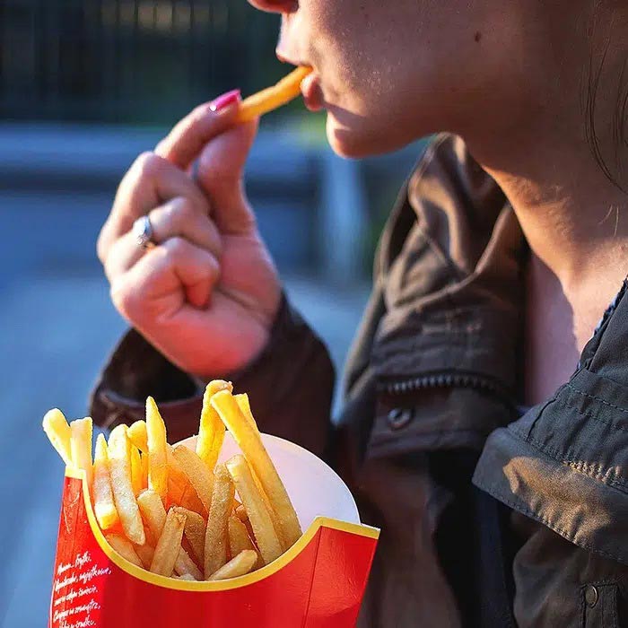 A girl eating french fries