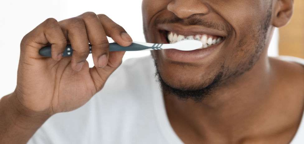 Closeup Shot Of Young Black Man Brushing Teeth